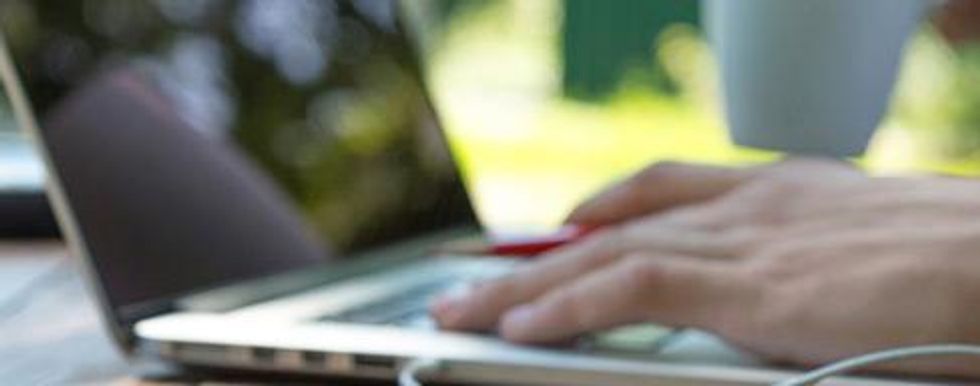 Close up of hands typing on a laptop