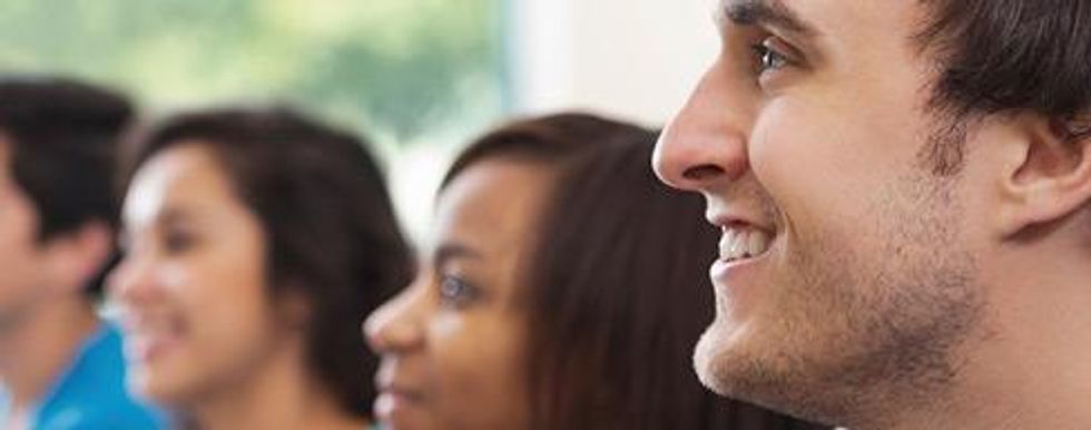 Closeup of a man in a crowd smiling