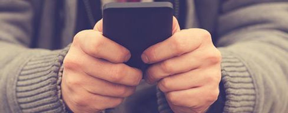 Closeup of hands texting on a phone