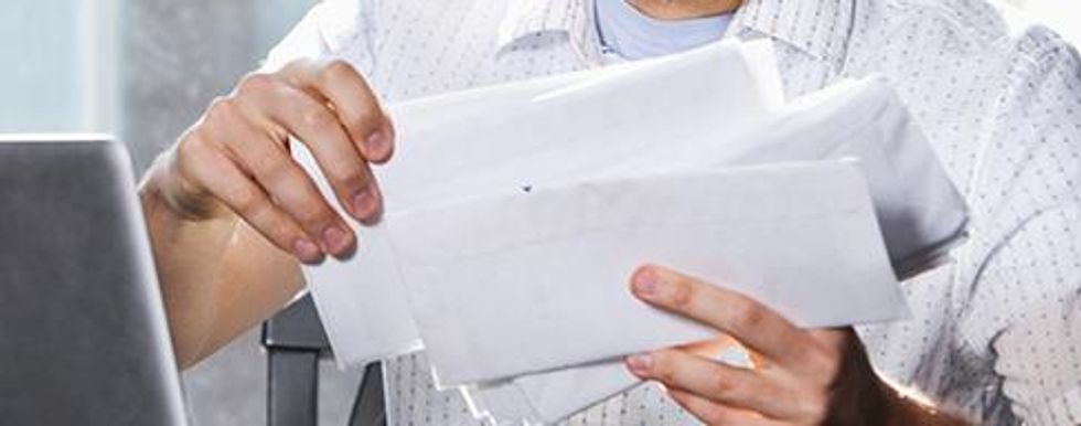 Man holding and reading letters