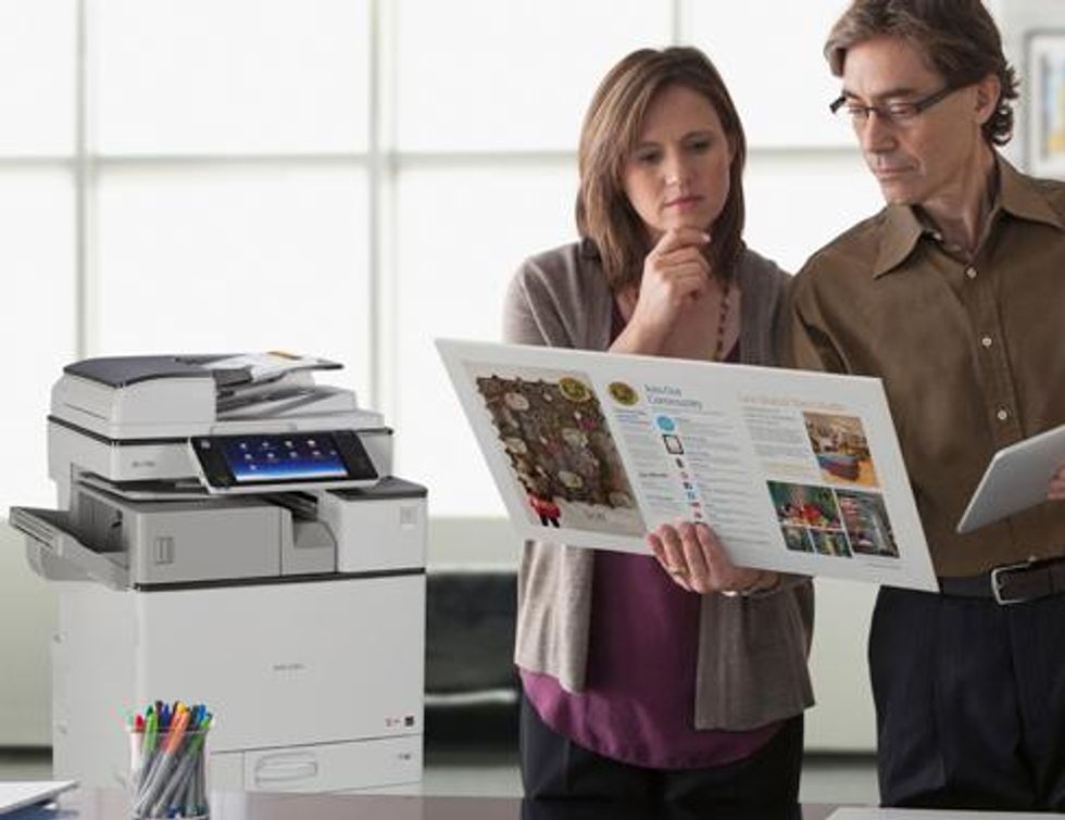Office employees looking at printed documents.